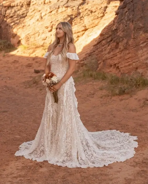 Bride-wearing-a-boho-wedding-dress-with-flowing-lace-sleeves Bride wearing a boho wedding dress with flowing lace sleeves